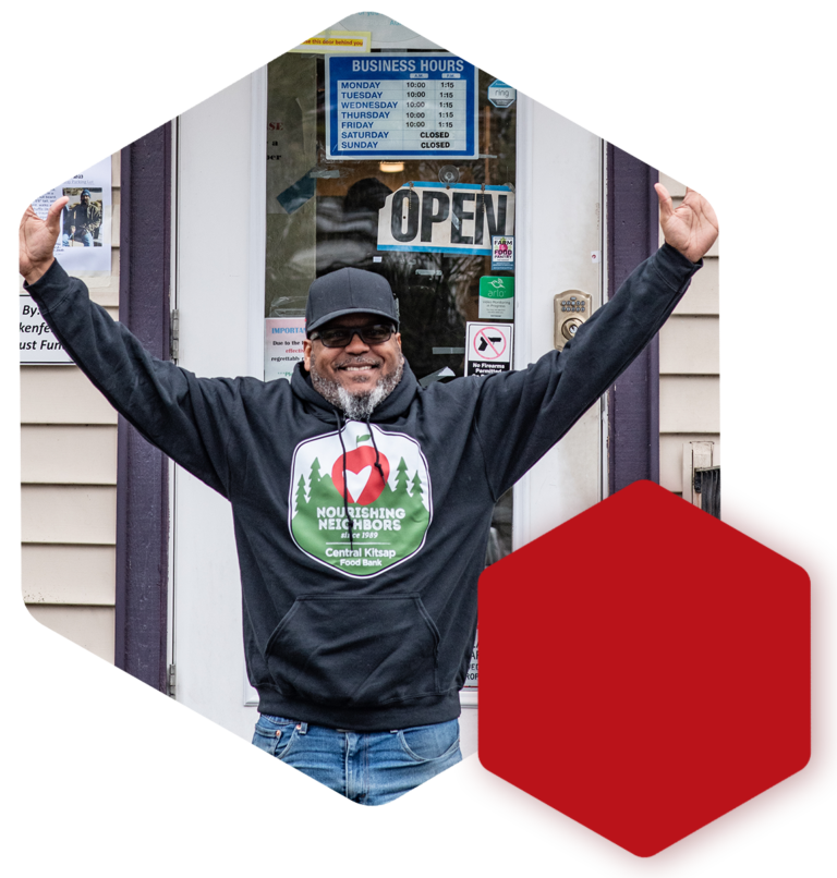 Photo of Director outside of the building hands in the air
